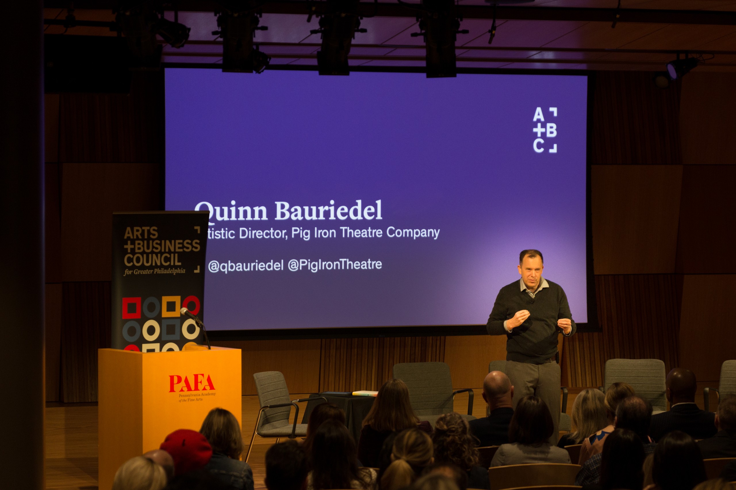 Photo of Defining Innovation speaker on stage addressing crowd
