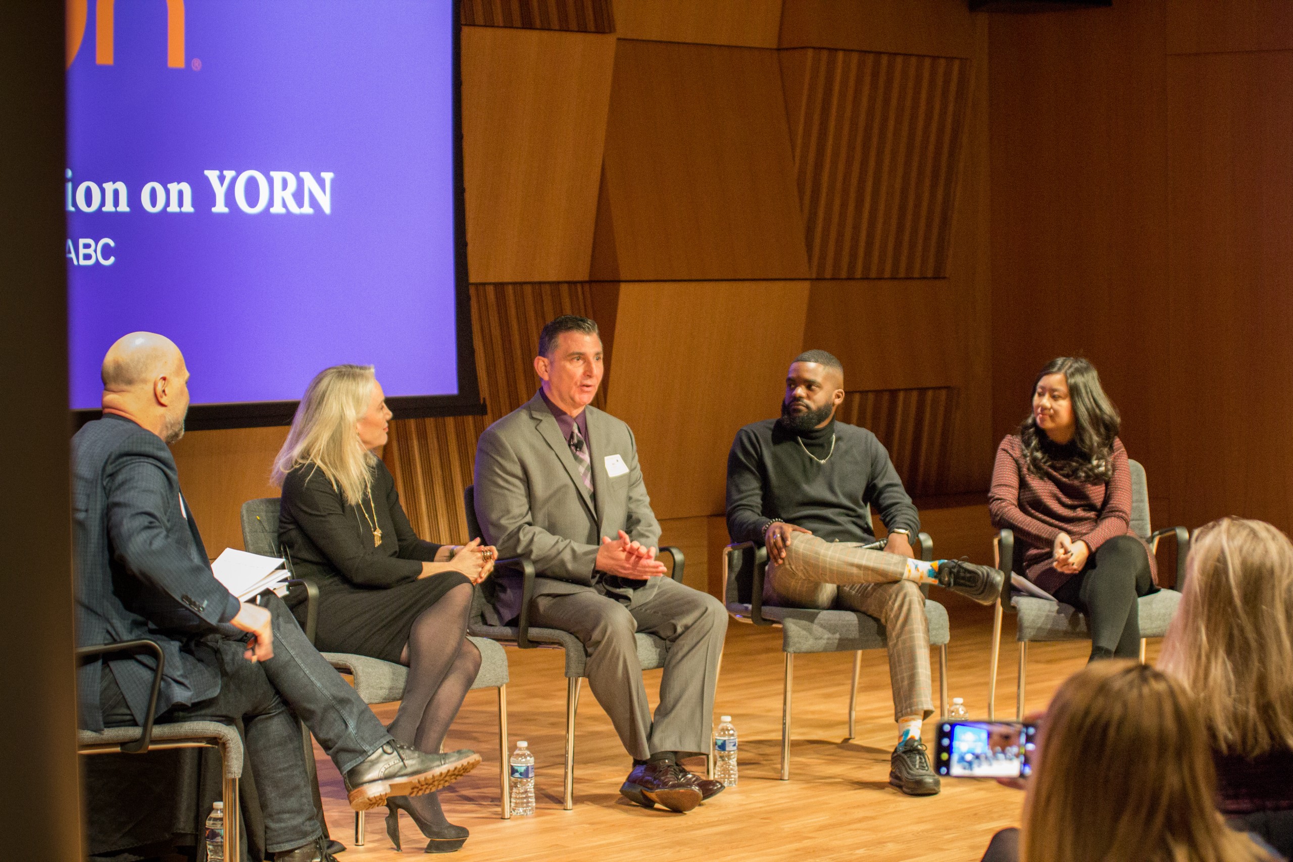 Photo of Defining Innovation speakers sitting on stage talking