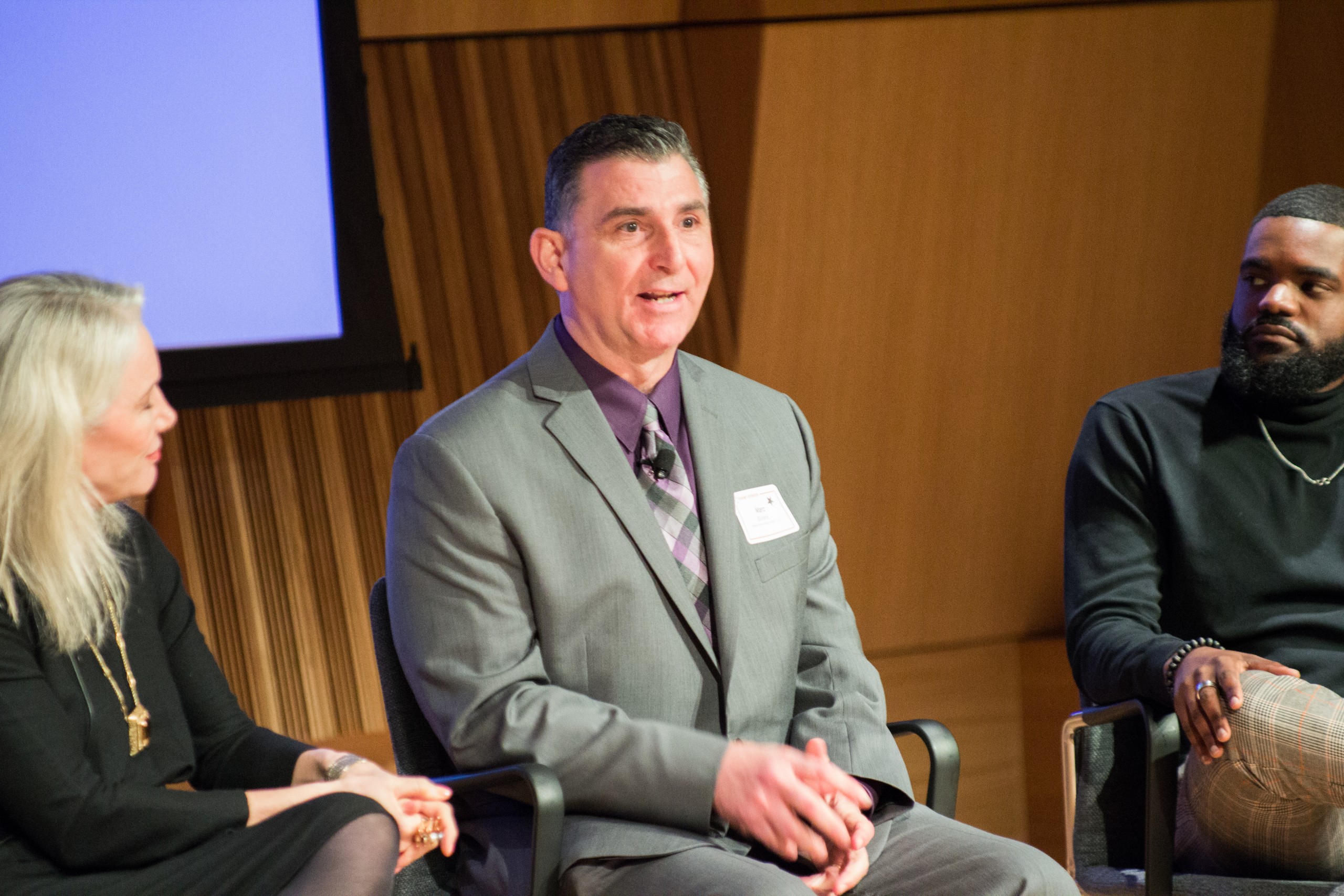 Photo of Defining Innovation speakers sitting on stage speaking