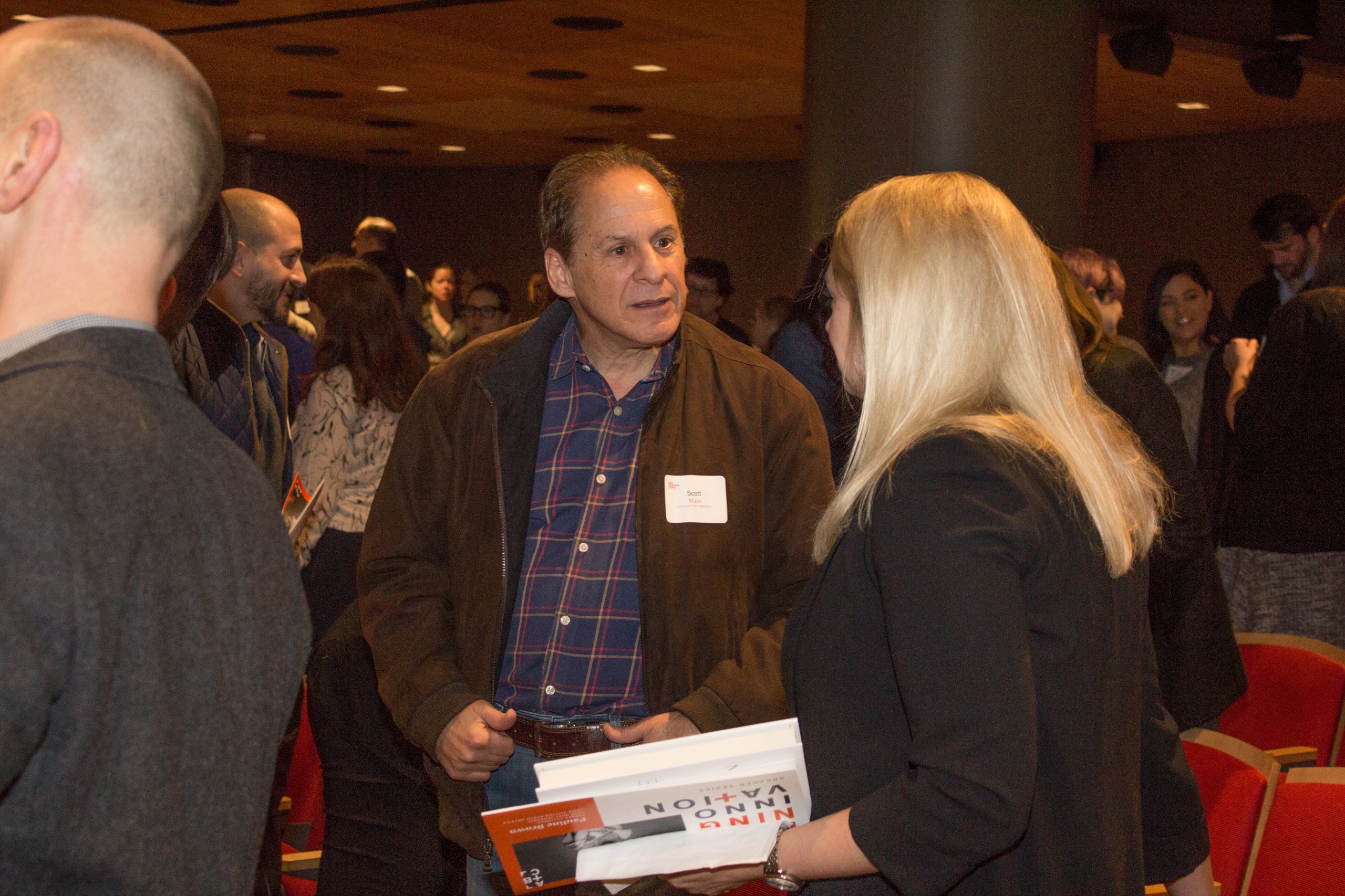 Photo of Defining Innovation speaker talking with attendee