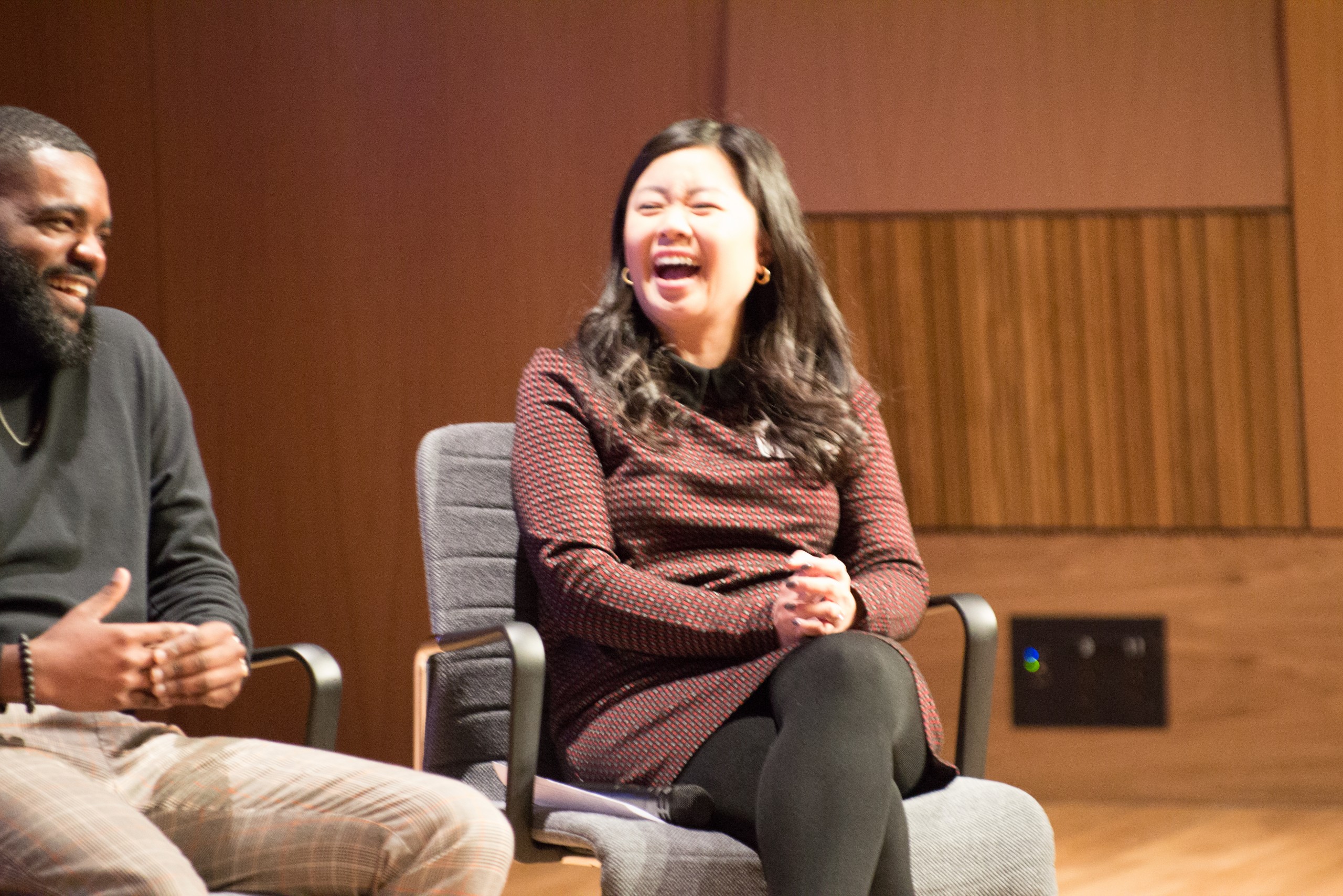 Photo of Defining Innovation speakers sitting on stage laughing